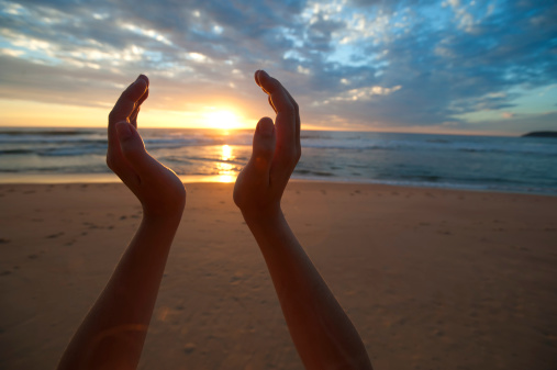 Hands holding the sunrise-gettyimages.com